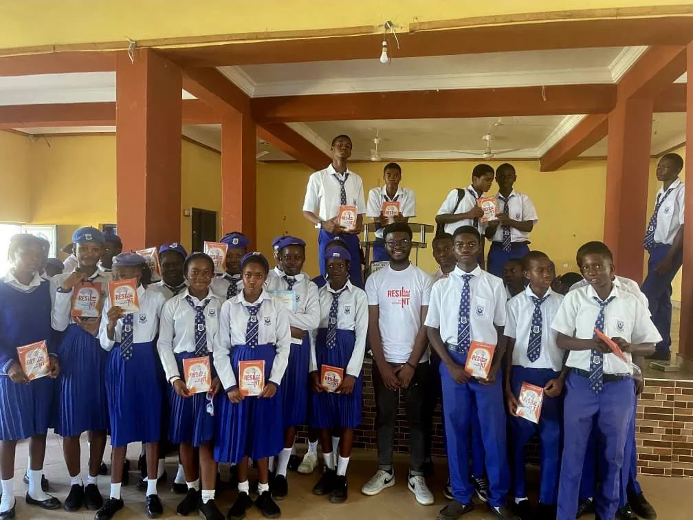 Secondary school students holding their Resilient by Design booklets.