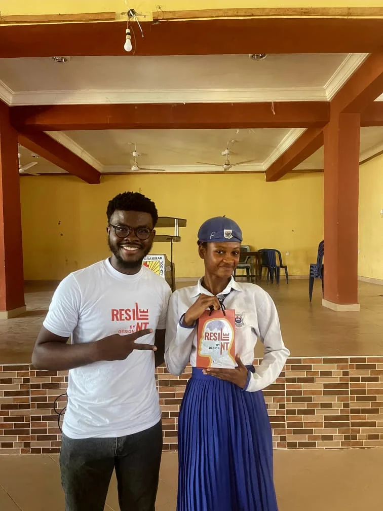 Makkan Innovation's CEO and a student holding a Resilient by Design booklet.
